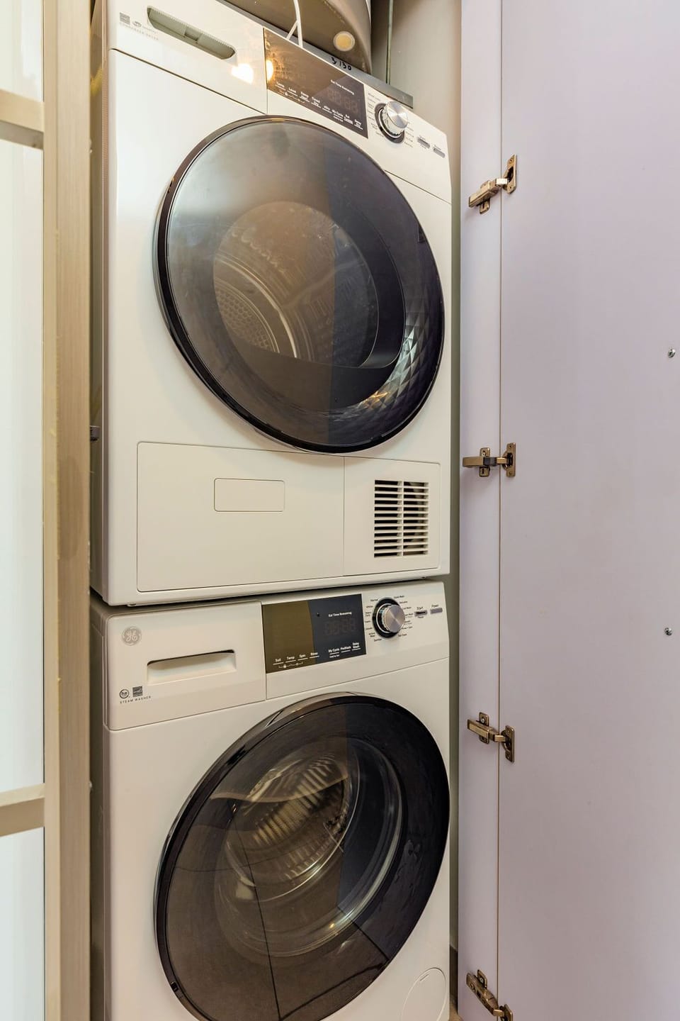 Your in-unit washer and dryer are stacked in a sleek closet, making laundry effortless during your stay.