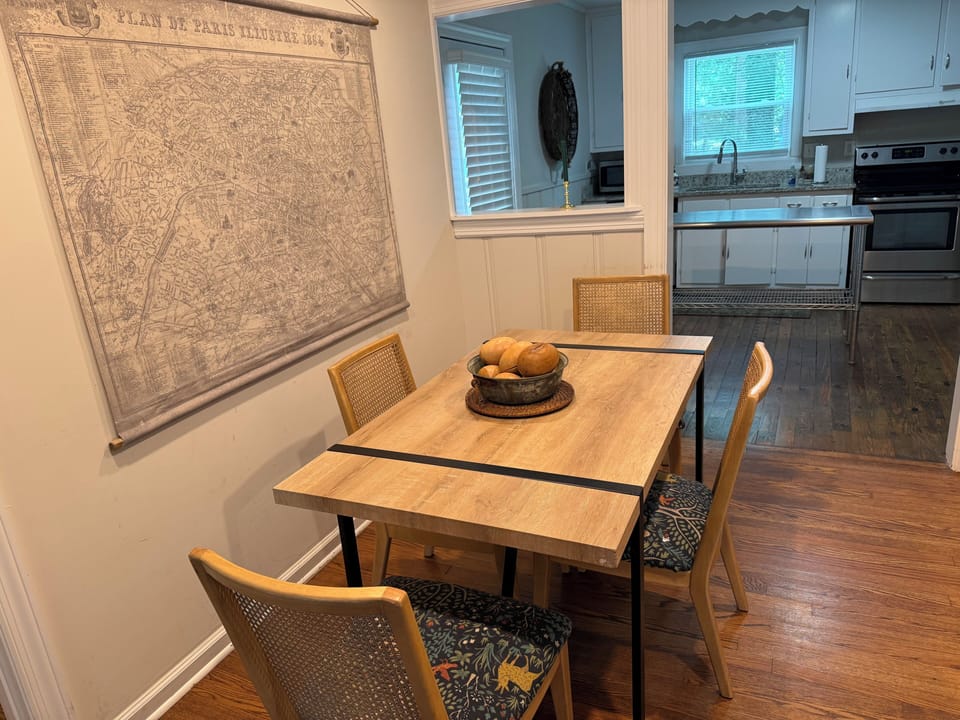 There are two more chairs in the living room, so this table could seat six