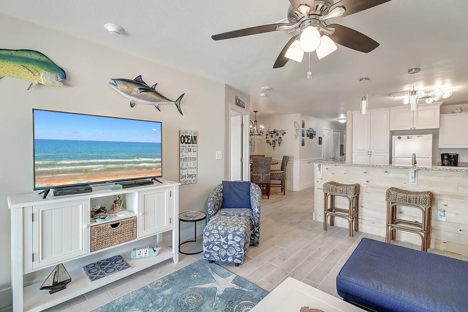 Sink into coastal comfort in your bright, airy living space where ocean-themed décor and natural textures create the perfect beach retreat atmosphere.