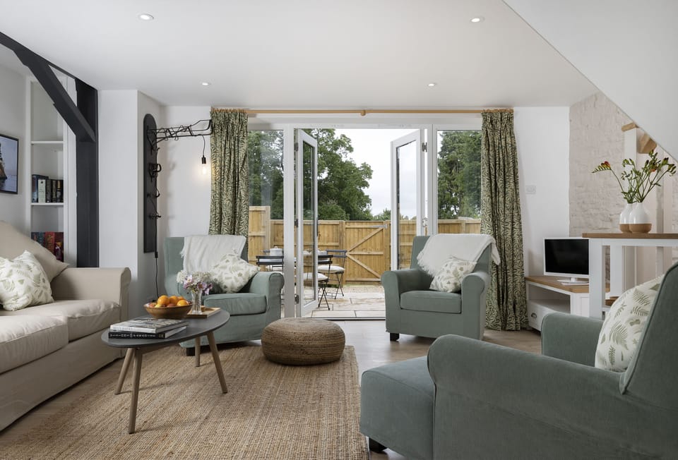 Ground floor: Cosy sitting room with french doors leading out to the pretty patio