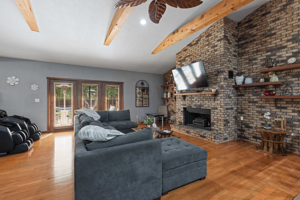 A cozy couch perfect for watching the game or your favorite movies while warming next to the fireplace