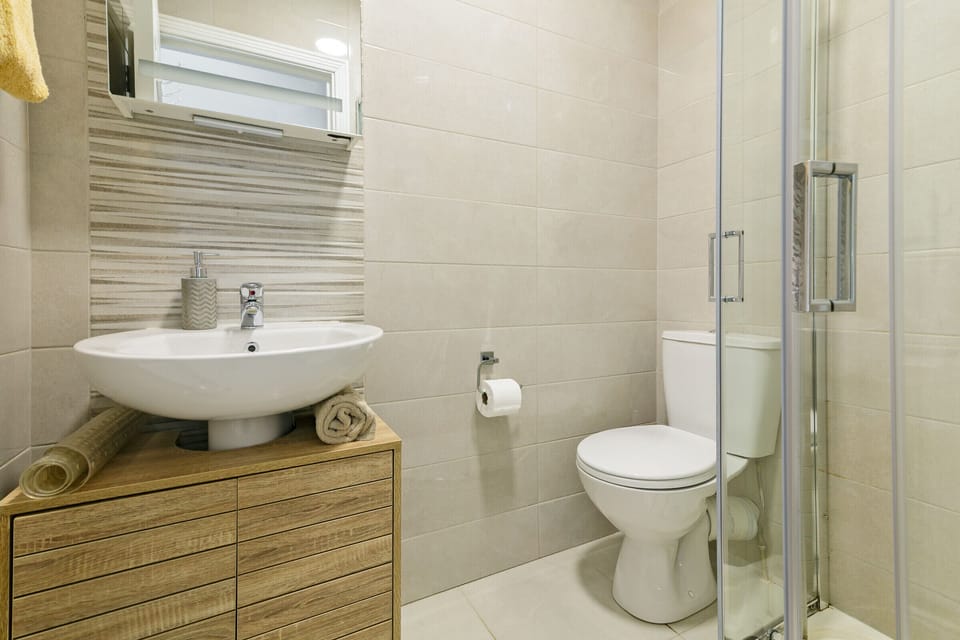 The bathrooms features metro style decor and fixtures with walk-in shower.
