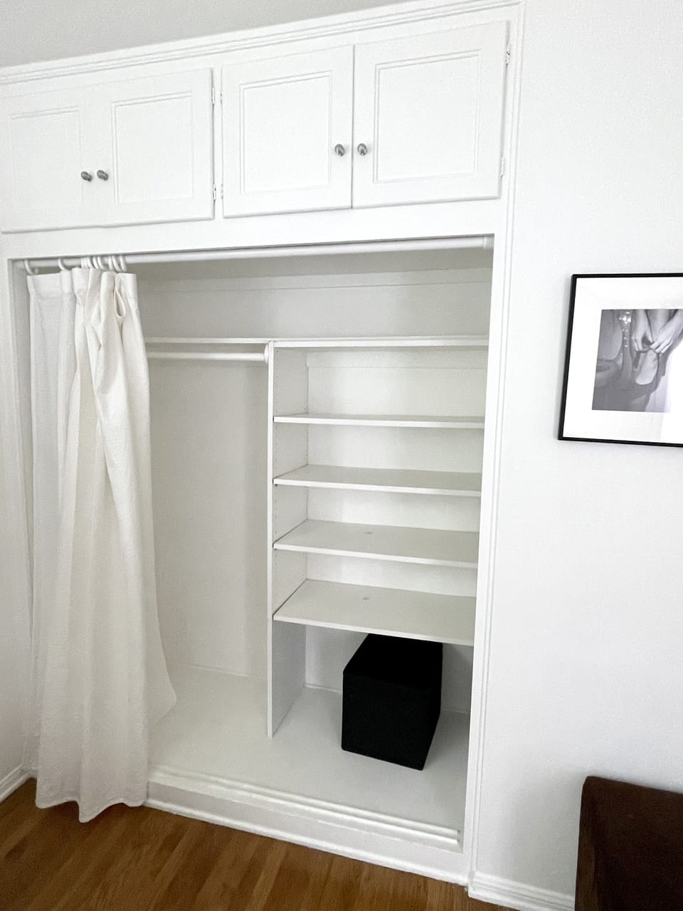 Storage / closet in room with double bed.