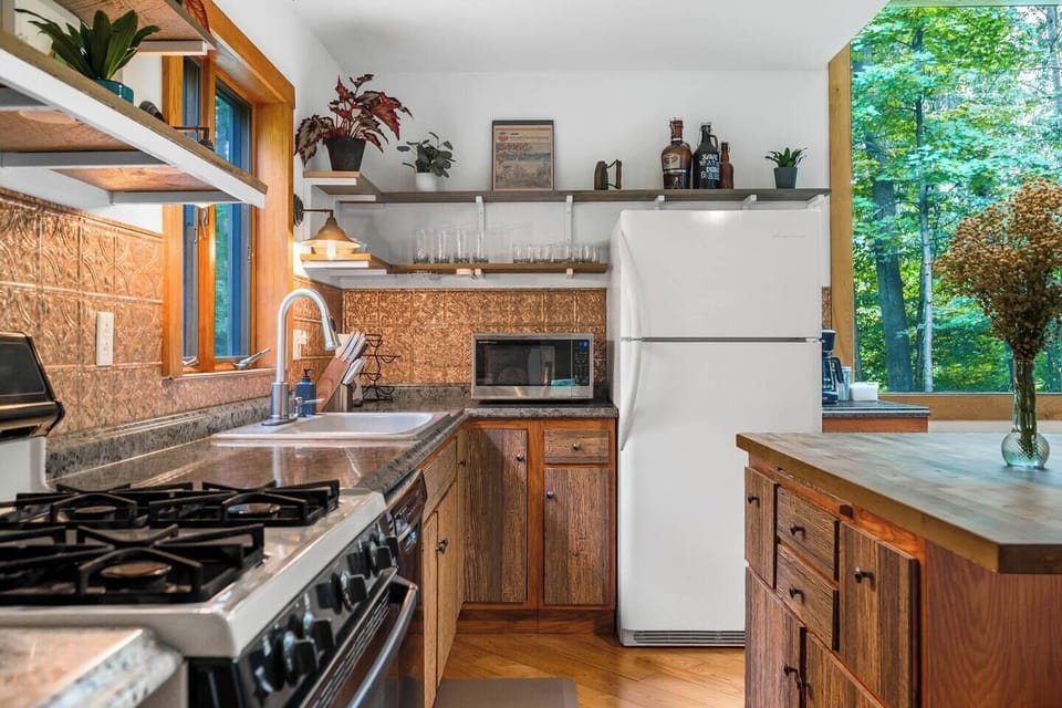 Cozy, warm, well-appointed kitchen overlooking open living spaces. 