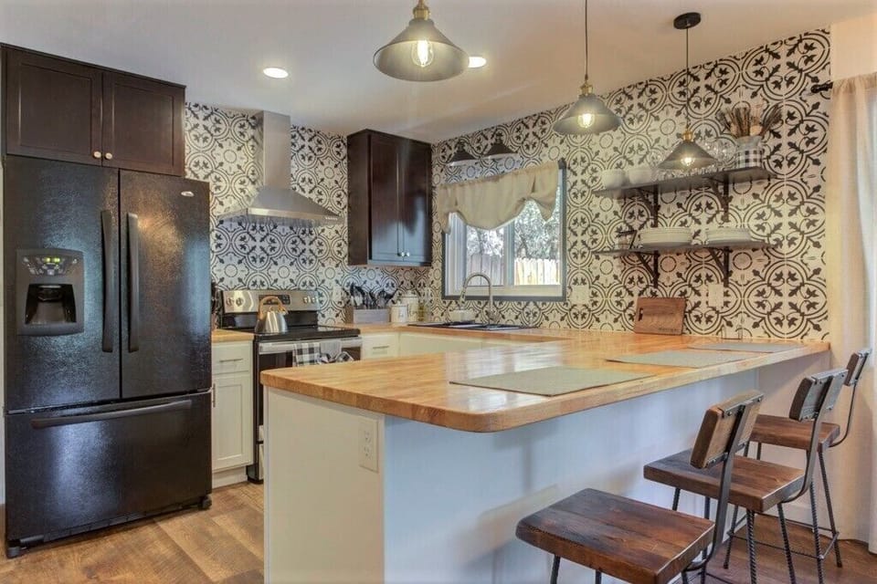New kitchen is equipped with everything you may need to cook at home.