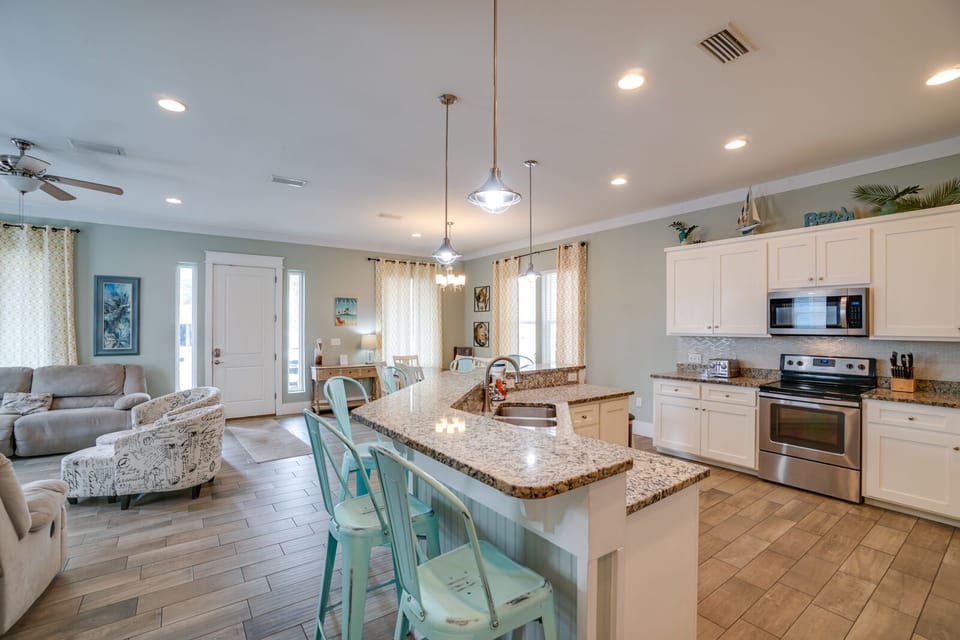 Your spacious open kitchen flows seamlessly into the living area, featuring granite countertops and modern appliances for effortless vacation cooking.