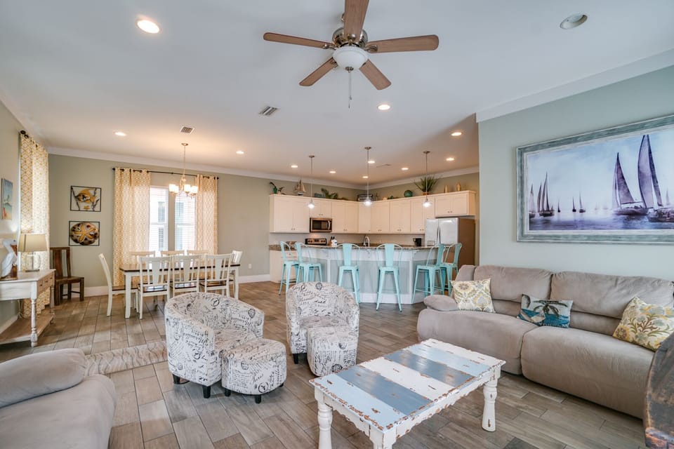 Your spacious open-concept living area invites relaxation with coastal charm, comfortable seating, and modern kitchen perfect for group gatherings.
