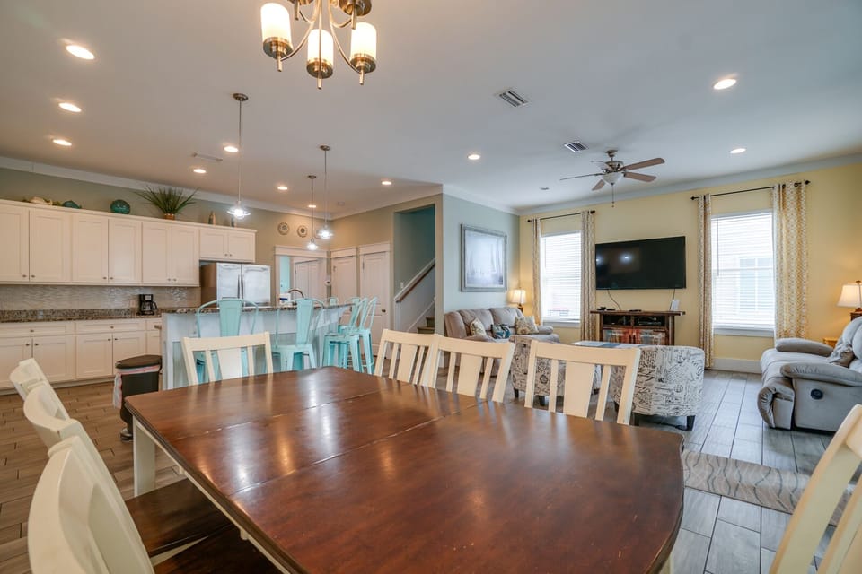 Gather your loved ones around this spacious dining table that flows seamlessly into your fully-equipped kitchen and cozy living room.