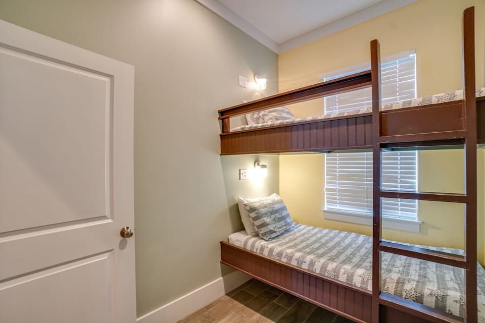 Rest peacefully in your cozy bunk room, where warm wood tones and soft linens create the perfect retreat after busy days.