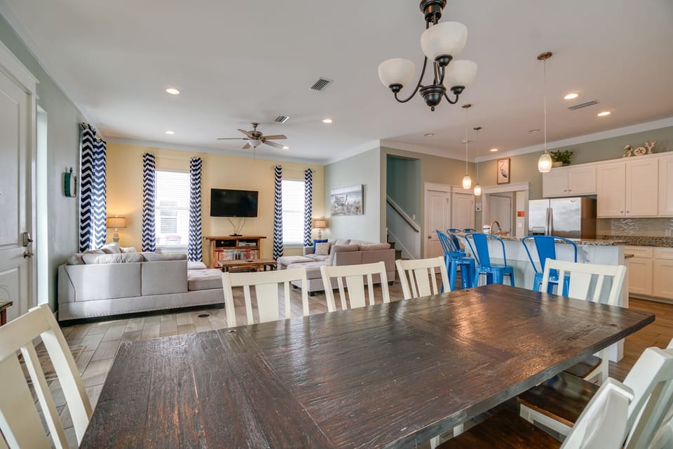 Gather your group around this spacious dining table while enjoying the open-concept flow to your fully equipped kitchen and cozy living area.