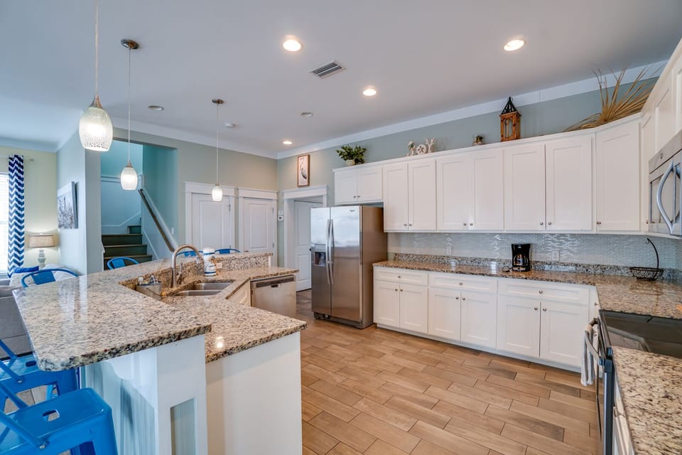 Whip up vacation memories in this spacious chef's kitchen featuring granite counters, stainless appliances, and a perfect island for gathering together.
