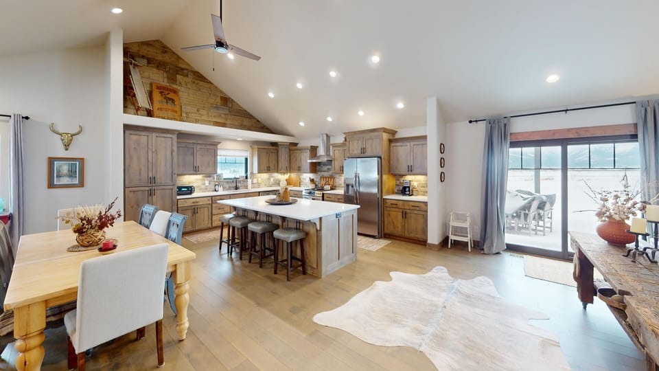 Gather with loved ones in this stunning open-concept kitchen featuring a spacious island, modern appliances, and warm wood cabinetry that invites culinary adventures.