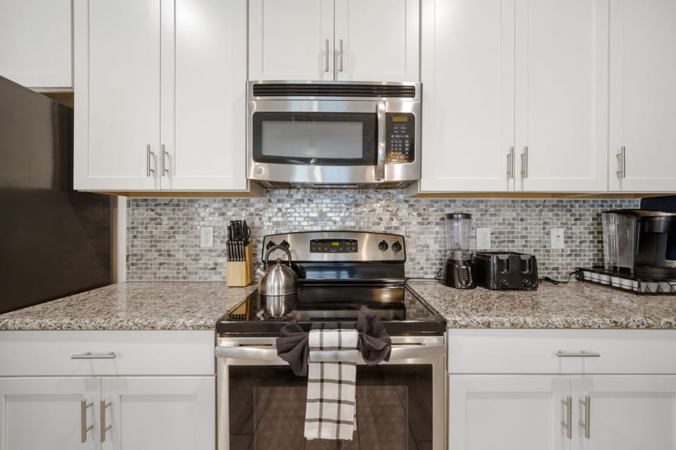 Fully equipped kitchen with a Keurig, Blender, toaster and lots of pots/pans.