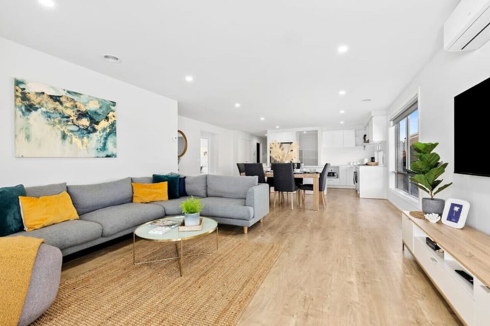 A spacious living room with live plants, air-conditioning, wide screen TV and a comfortable sofa to relax on after enjoying the day!