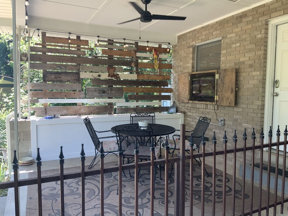 outdoor covered sitting area with tv