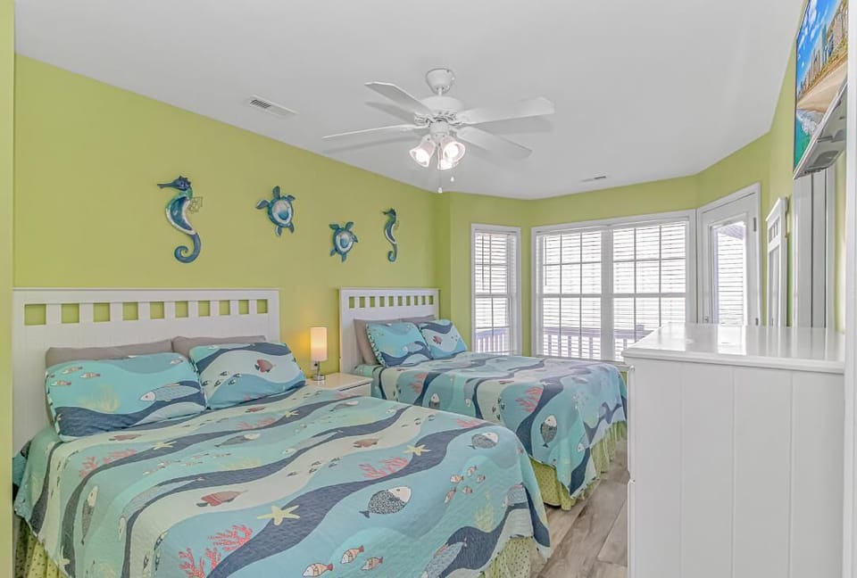 Another view of 2 full beds in yellow bedroom