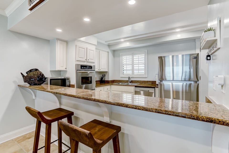Fully Equipped Kitchen with Granite Countertops, Stainless Steel Appliances, and Gorgeous Ocean Front Views