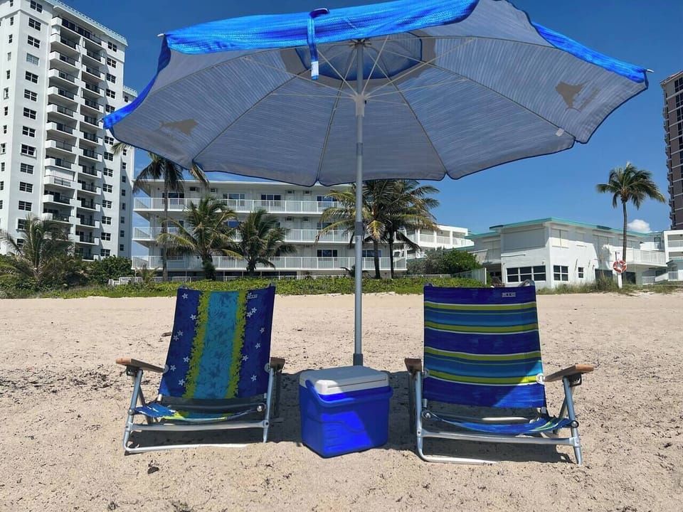 Beach umbrella, beach chairs and a cooler. (1)