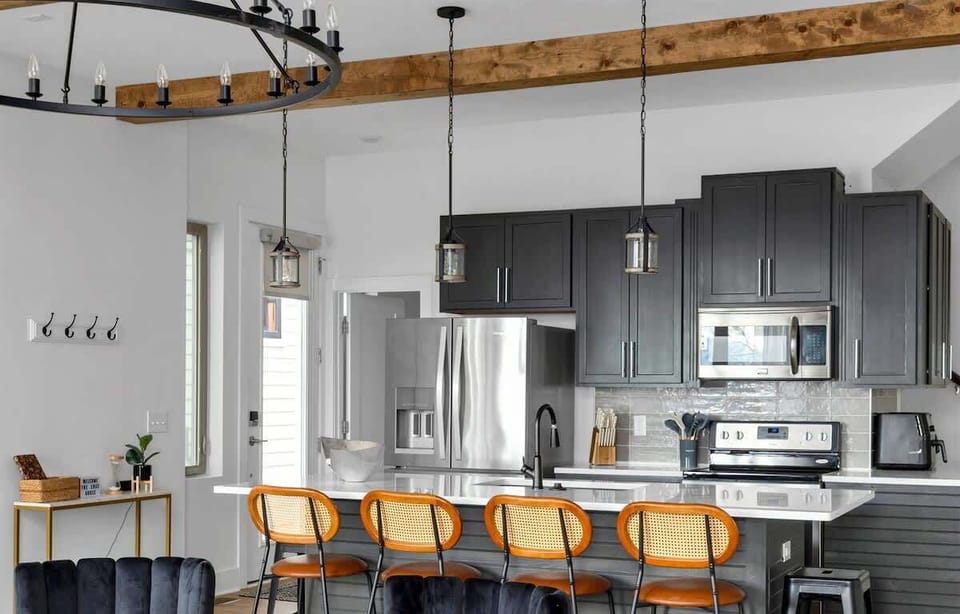 Gather, cook, and chat at a fully stocked kitchen with four-stool island.