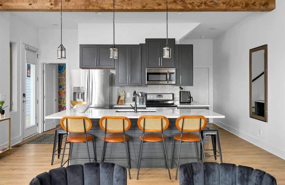 Remodeled kitchen with a spacious island and seating for four, perfect for cooking, dining, and gathering together.