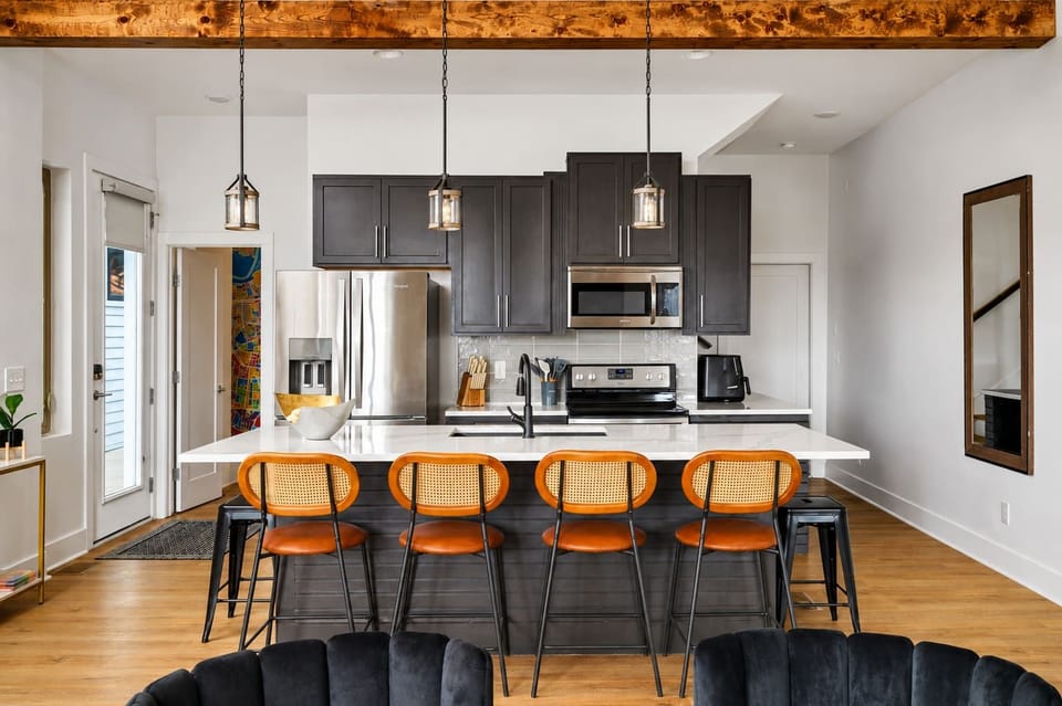 Remodeled kitchen with a spacious island and seating for four, perfect for cooking, dining, and gathering together.