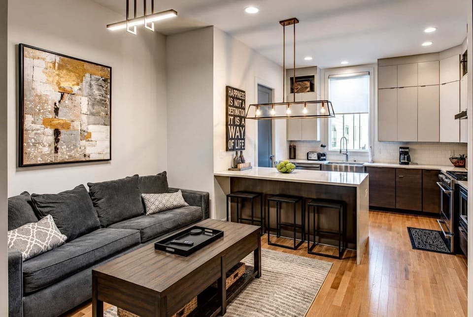 Contemporary open-concept living area with a connected kitchen, perfect for relaxing, gathering, and entertaining.