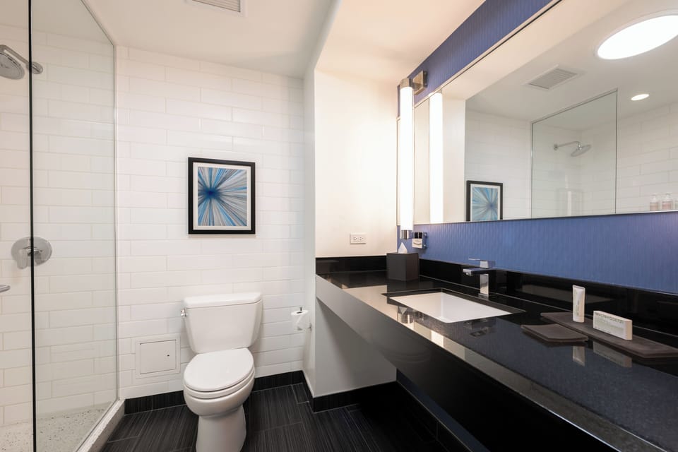 Shower, designer toiletries, hair dryer, bathrobes