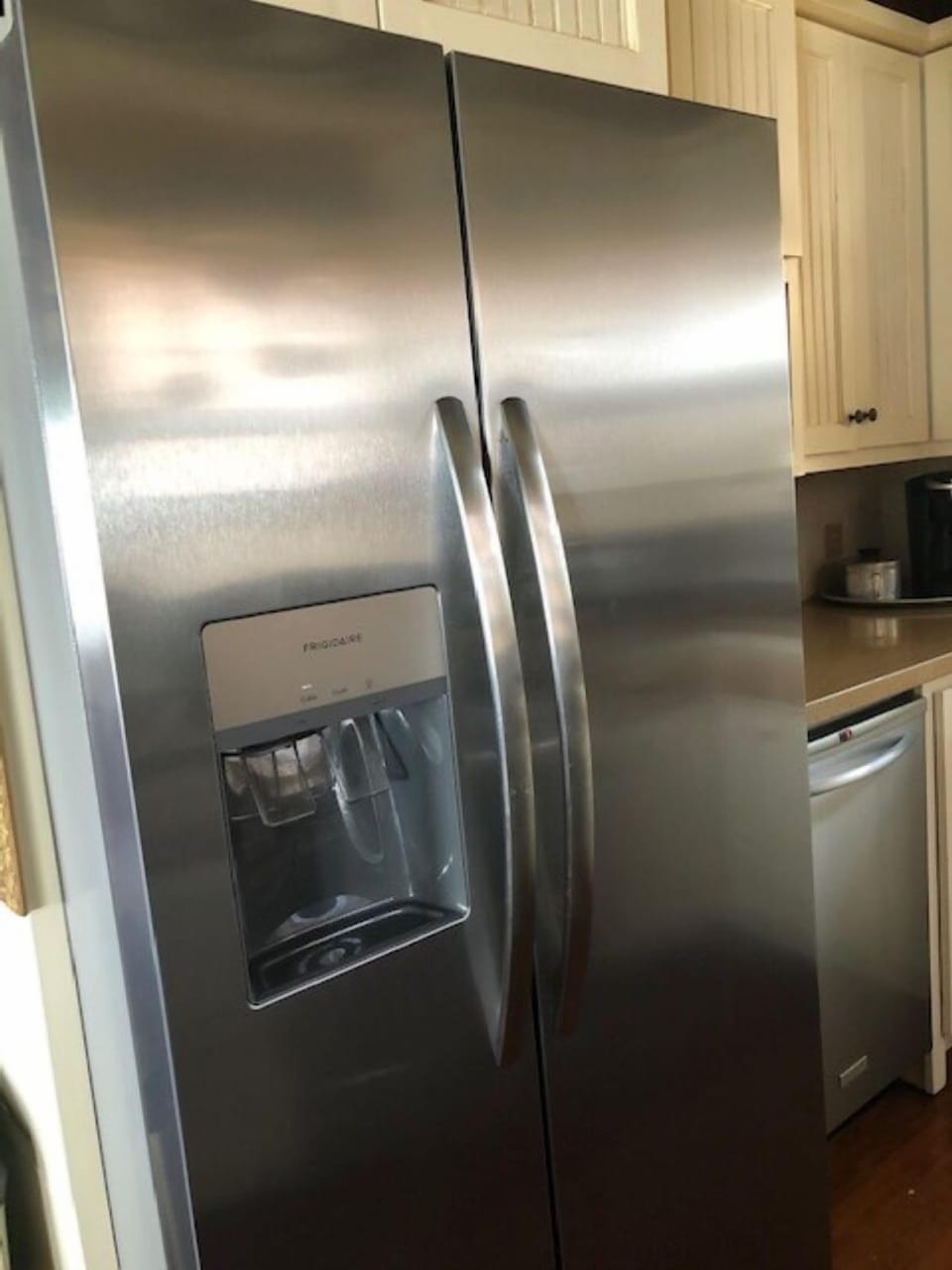 Stainless steel side-by-side refrigerator with ice and water in the door.