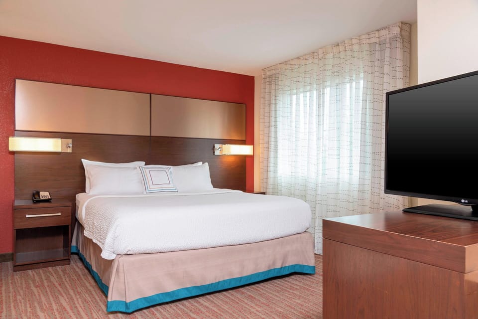 Hypo-allergenic bedding, desk, laptop workspace, blackout drapes