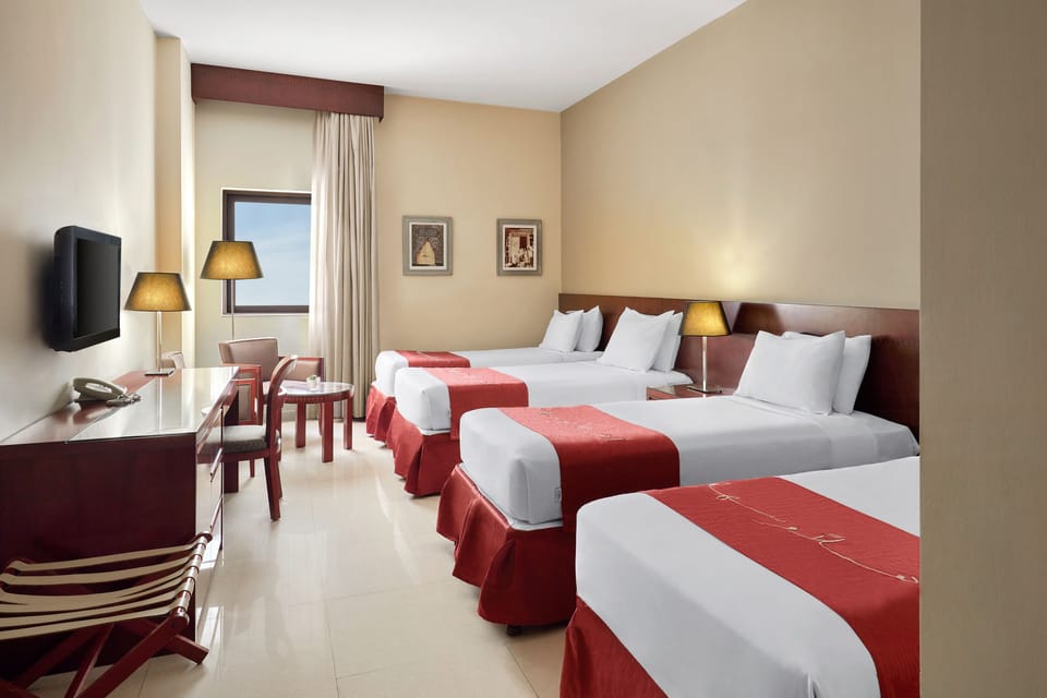 Standard Quadruple Room | Minibar, in-room safe, desk, laptop workspace