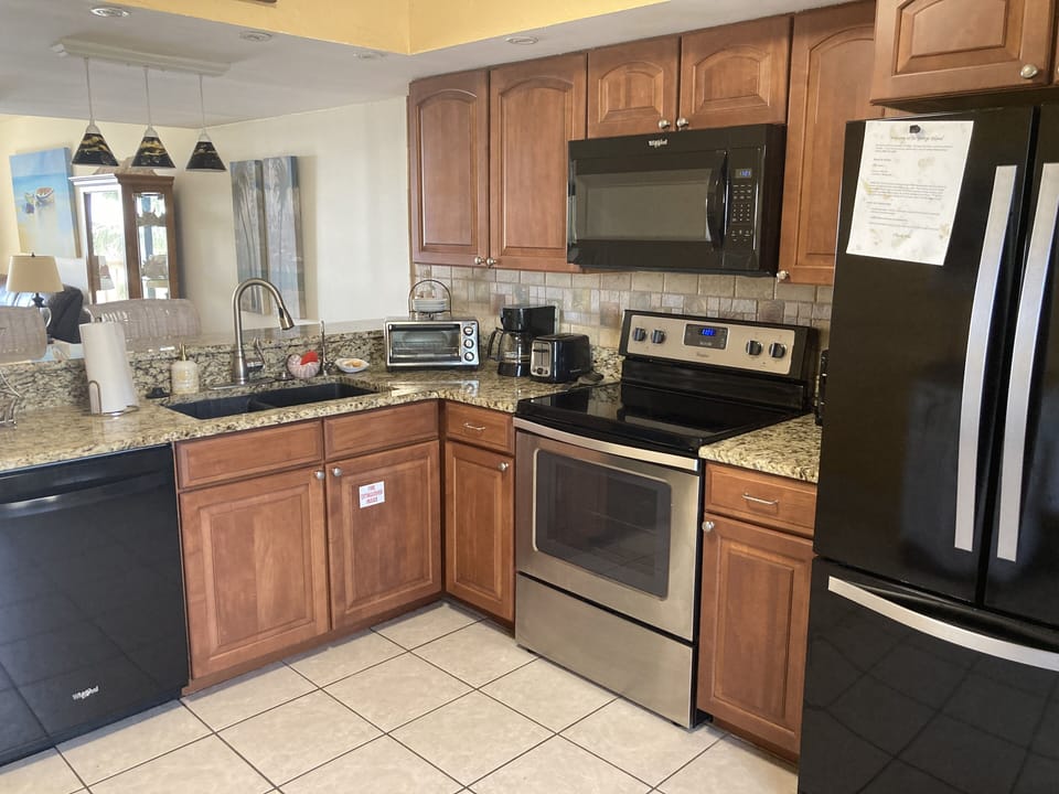 Kitchen with refrigerator, range, microwave and dishwasher