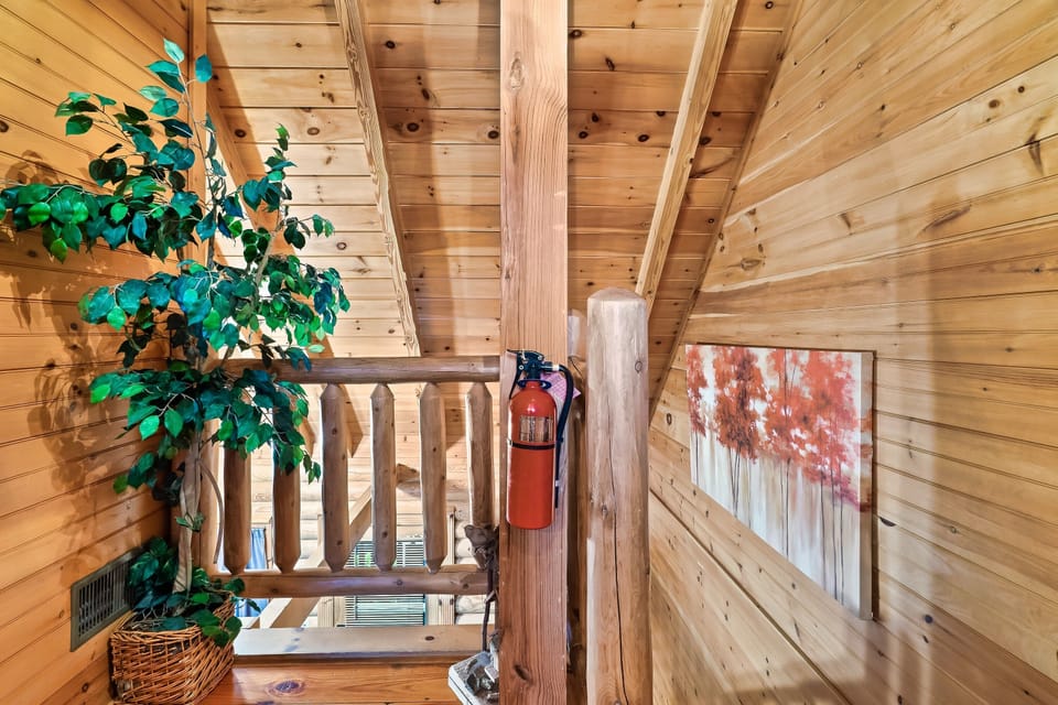 Stair landing with fire extinguisher. *2nd fire extinguisher in kitchen cabinet
