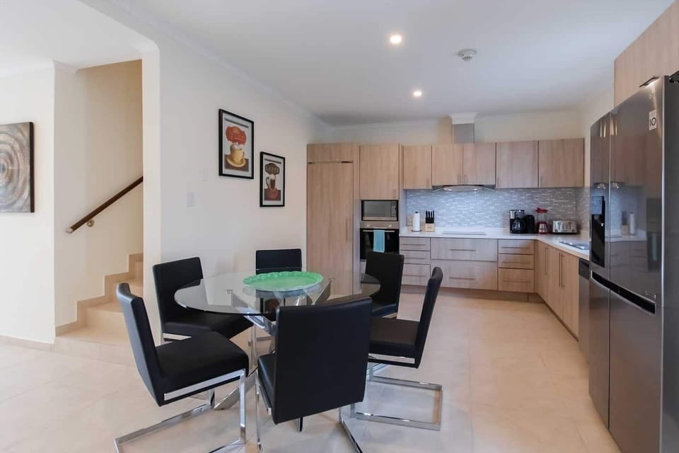 Spacious kitchen with large fridge, microwave, stove, oven, coffee maker.