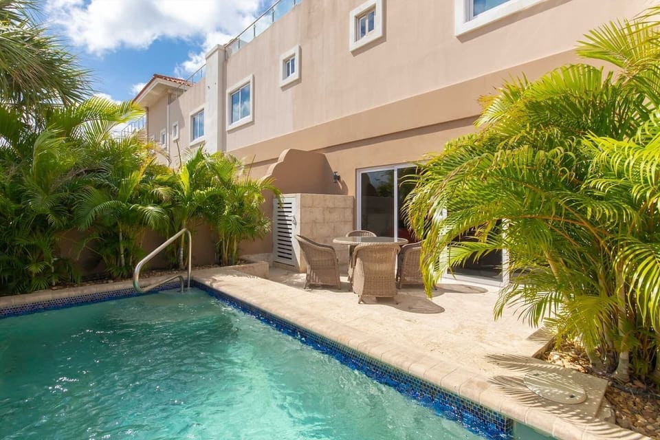 Back patio with private pool, seating area and outdoor shower.