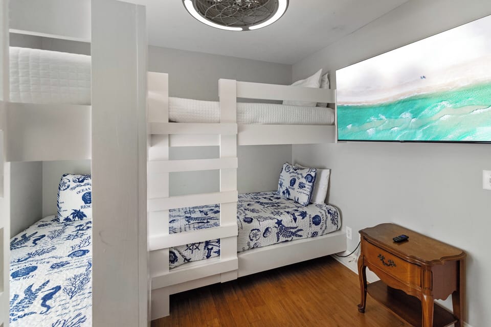 Your family will love this cozy room with custom-built bunk beds dressed in ocean-inspired bedding. Perfect for the kids to unwind after a day at the beach.