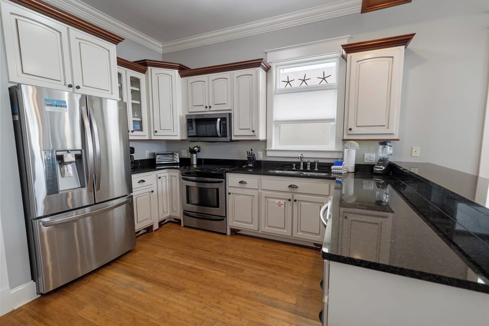 Your fully equipped kitchen features gleaming granite counters, stainless appliances, and plenty of space to prep meals or gather with loved ones over morning coffee.