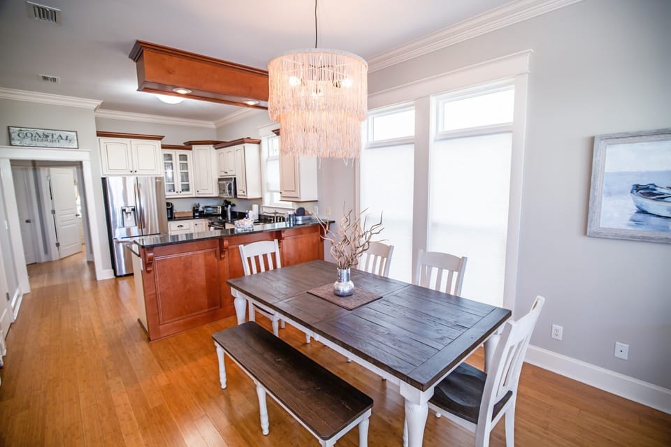 Your open kitchen flows seamlessly into this elegant dining space, where a beautiful chandelier sets the mood for memorable meals together.