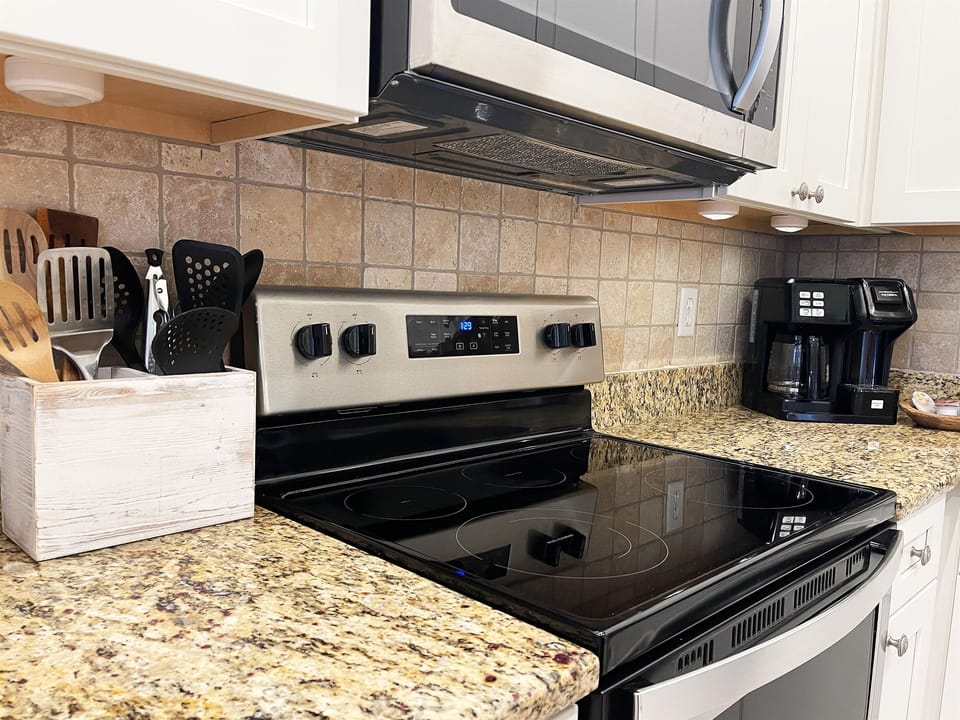 Stainless steel appliances and pot or single cup coffee in chef's kitchen