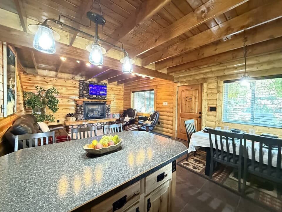 The open kitchen blends seamlessly into the cabin's cozy living area, creating a welcoming space perfect for gathering and unwinding.