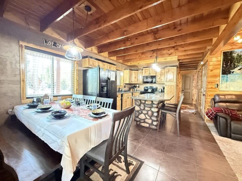 The open kitchen blends seamlessly into the cabin's cozy living area, creating a welcoming space perfect for gathering and unwinding.