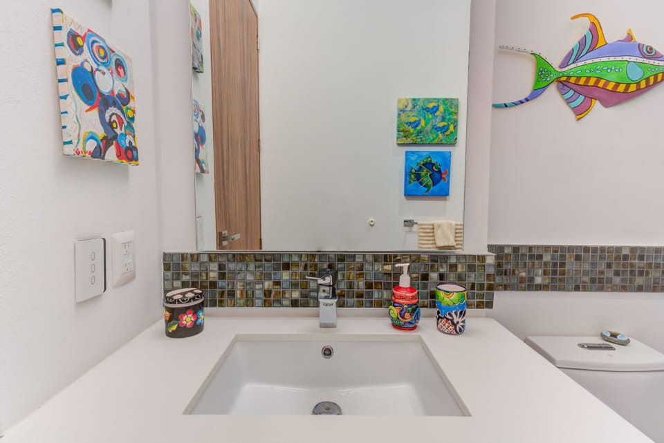 Appreciate the fine details with custom mosaic backsplash tilework and whimsical hand-painted artisan touches that bring an upscale beach vibe indoors.
