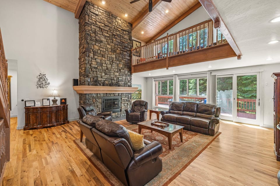 Living room has high ceilings with an open loft.