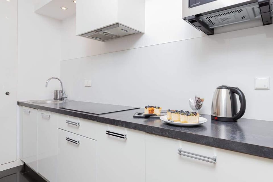 Kitchen with plenty of kitchen utensils and dishes. 