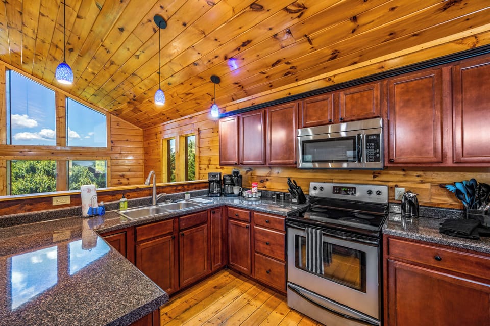Fully Equipped Kitchen – Stainless steel appliances, wooden accents