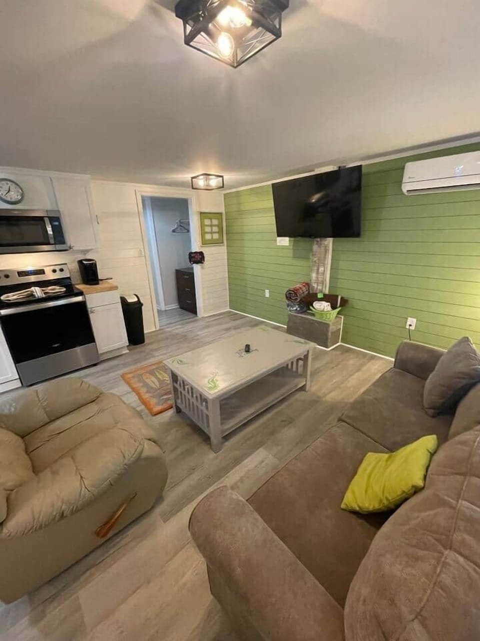 Comfy living area with 55" smart TV, kitchen close by for a quick snack