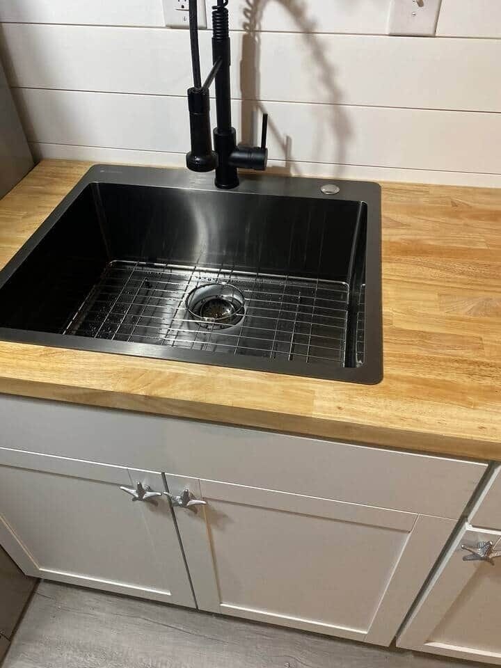 Large black stainless sink with sprayer faucet