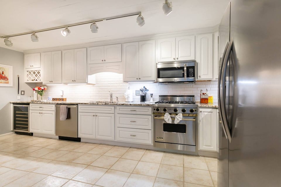 The kitchen has all new stainless steel appliances, including a beverage fridge.