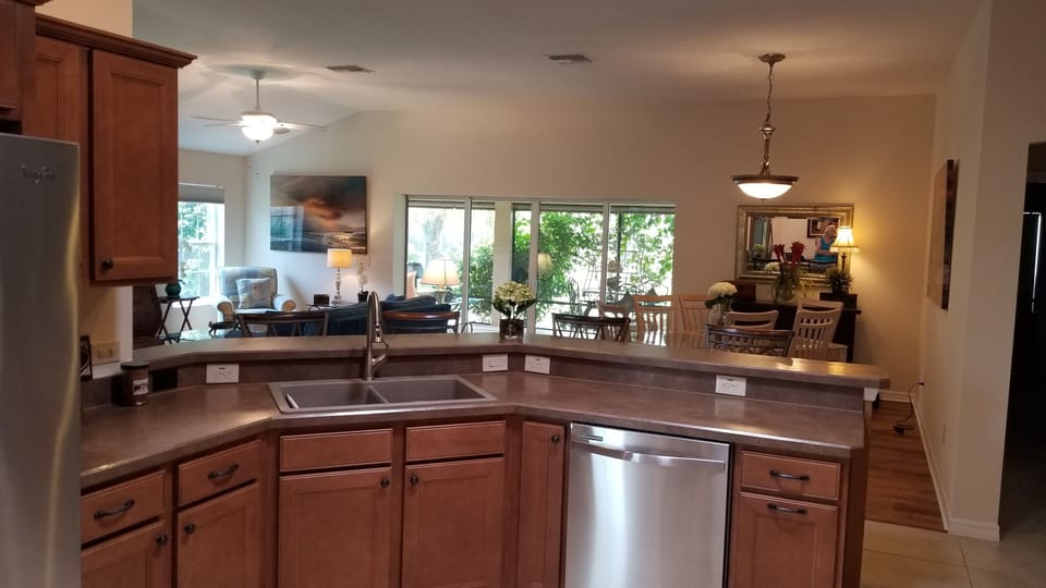 KITCHEN LOOKING INTO LIVING AREA AND DINING ROOM