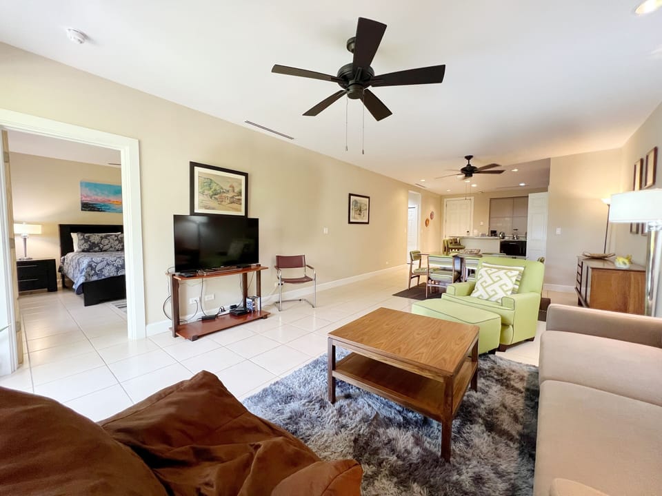 The bright living space features a 50" smart TV and comfortable furnishings. 