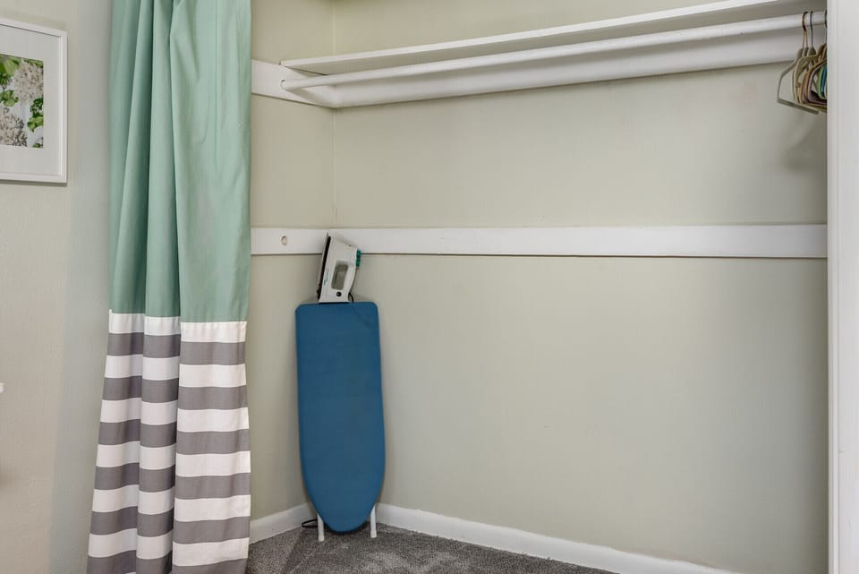 Lots of closet space throughout, including hangers, iron and ironing board
